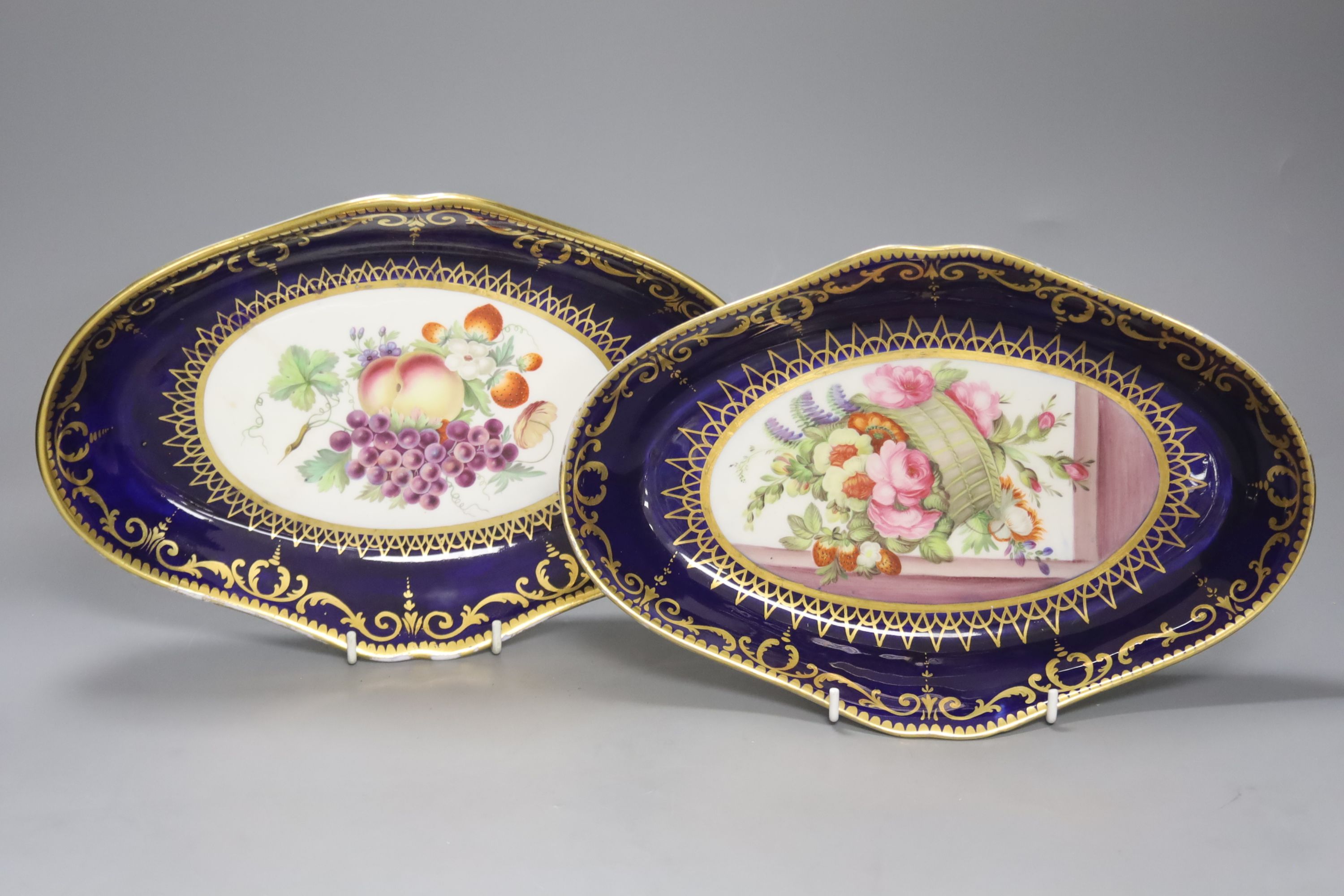 A pair of Coalport oval dishes, painted with fruit under blue border, c.1810, length 29cm